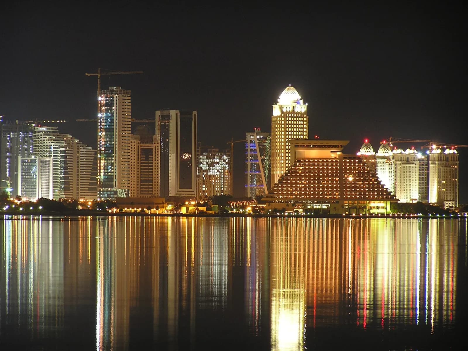 Doha skyline reflected in the bay at night