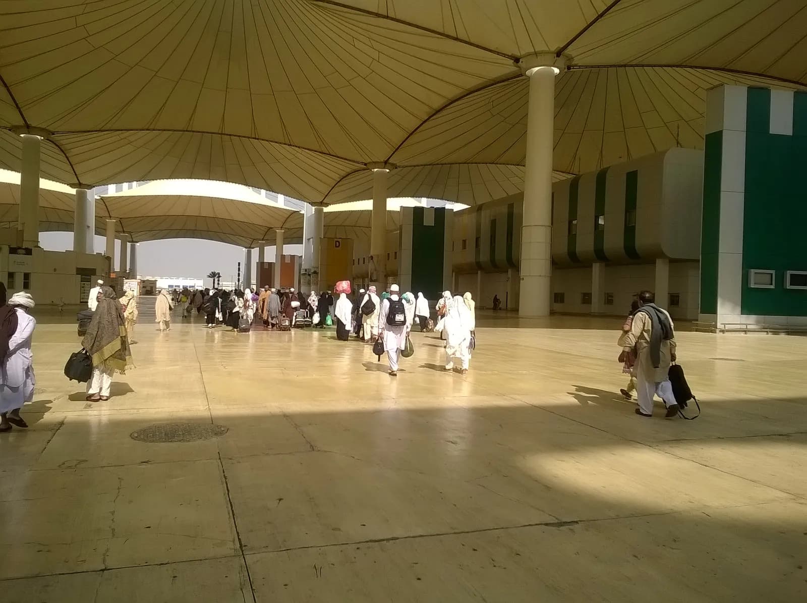 Pilgrims walking beneath the tented roof of the Hajj Terminal