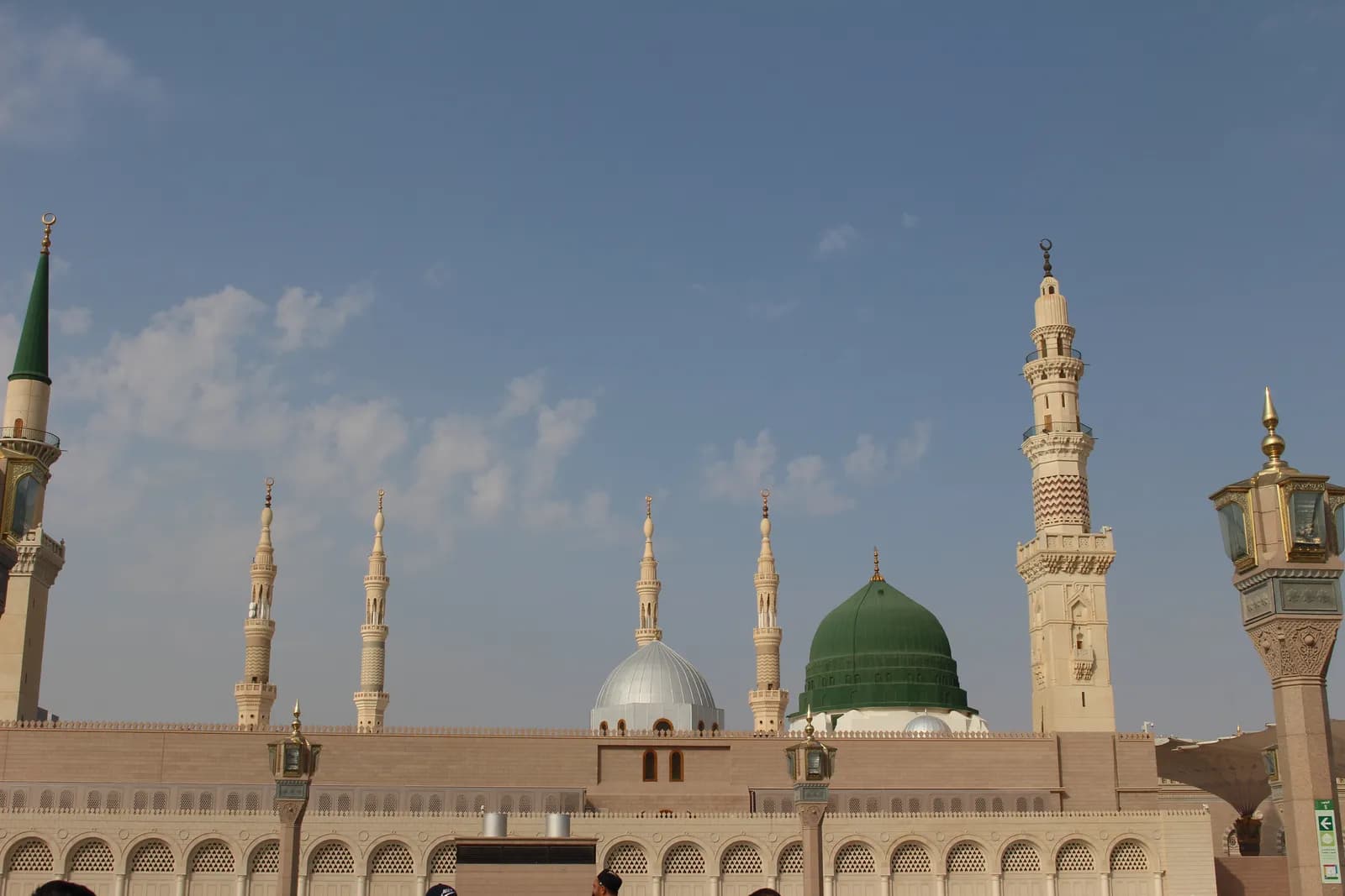 The Green Dome and minarets of the Prophet's Mosque under a clear sky