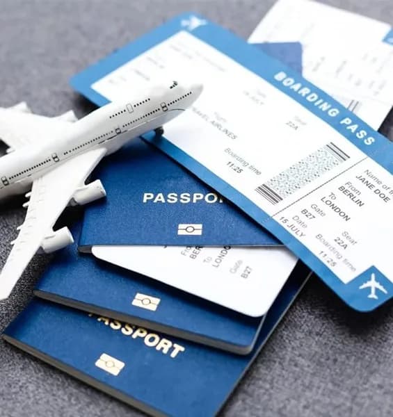 Passports, boarding passes and a model aircraft on a table